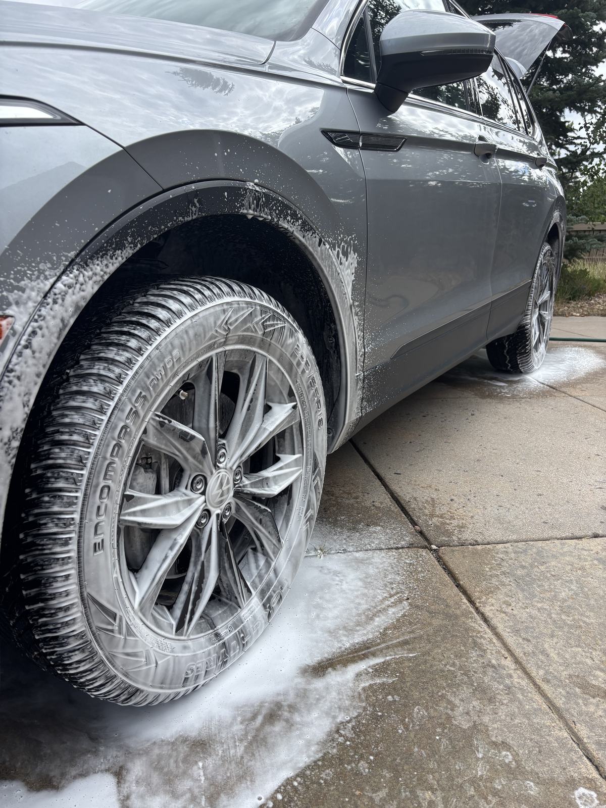 Wheel covered in cleaning foam during a wash