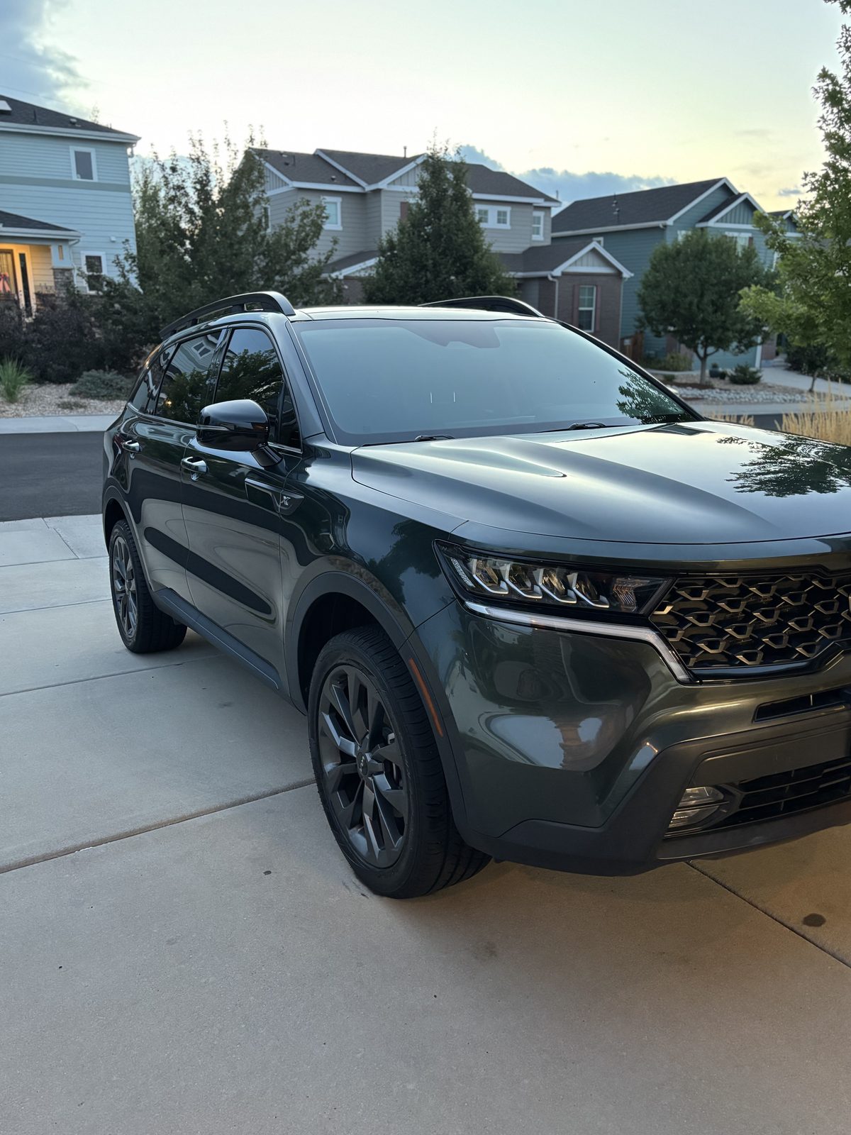 Dark green Kia SUV after an exterior detail