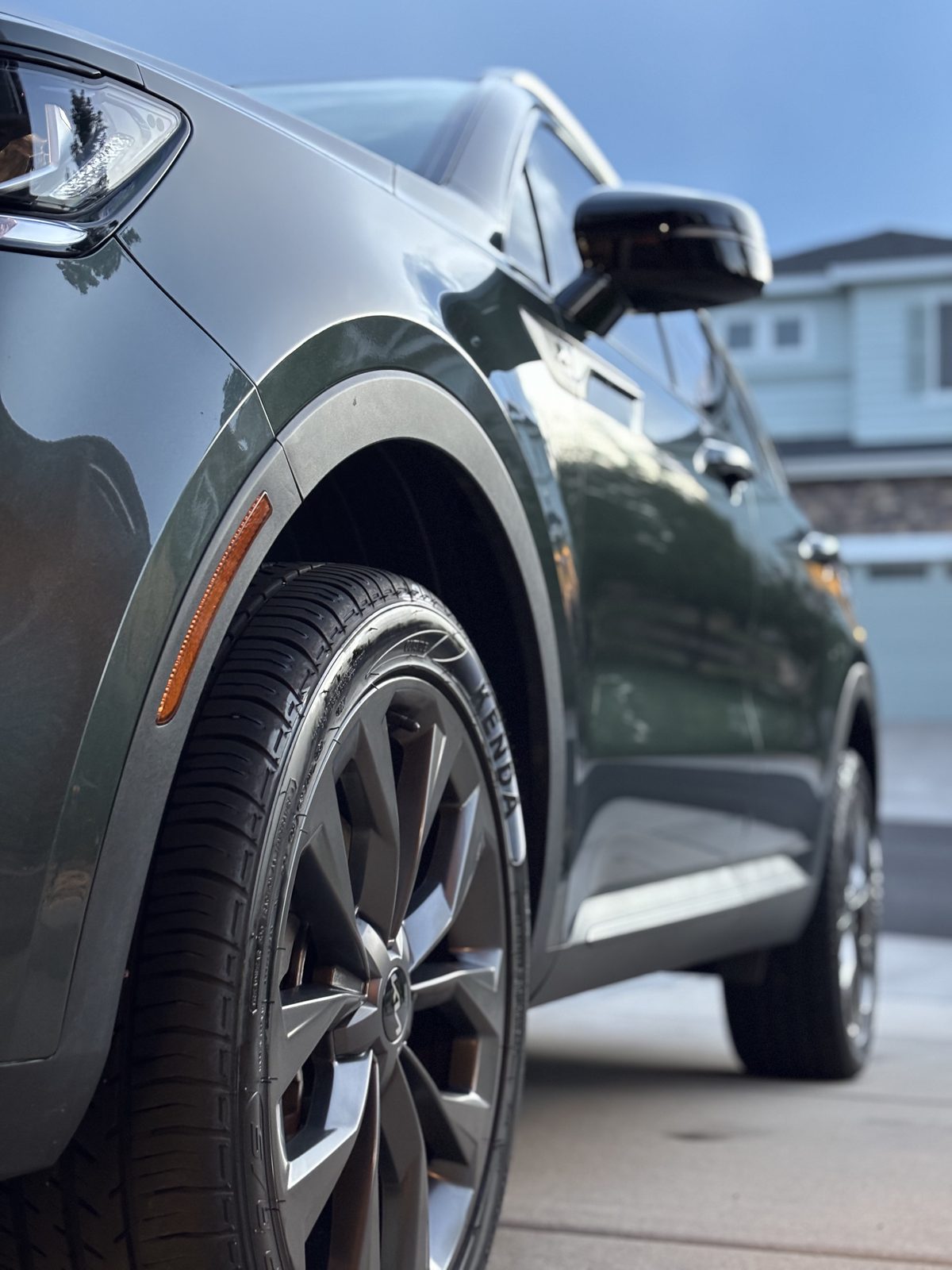 Clean wheel and paintwork on a dark green SUV